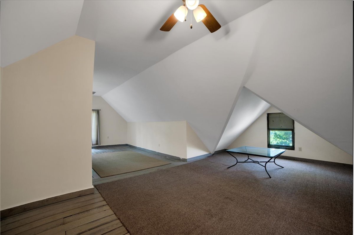 155 Chicago Road Oswego, IL 60543 - Photo 37 of 50 a view of an empty room with wooden floor and a ceiling fan