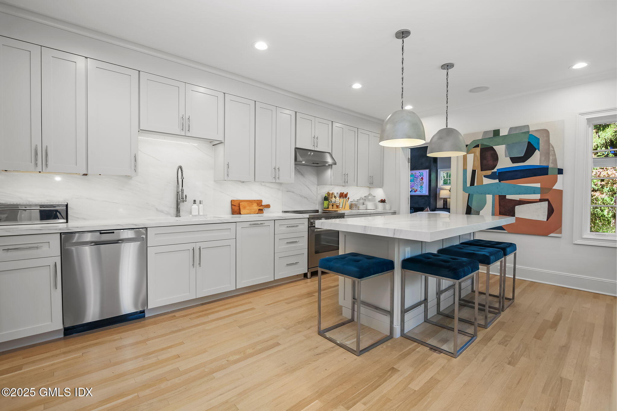 7 Stanwich Road Greenwich, CT 06830 - Photo 18 of 38 a kitchen with stainless steel appliances granite countertop a sink a stove a dining table and chairs with wooden floor