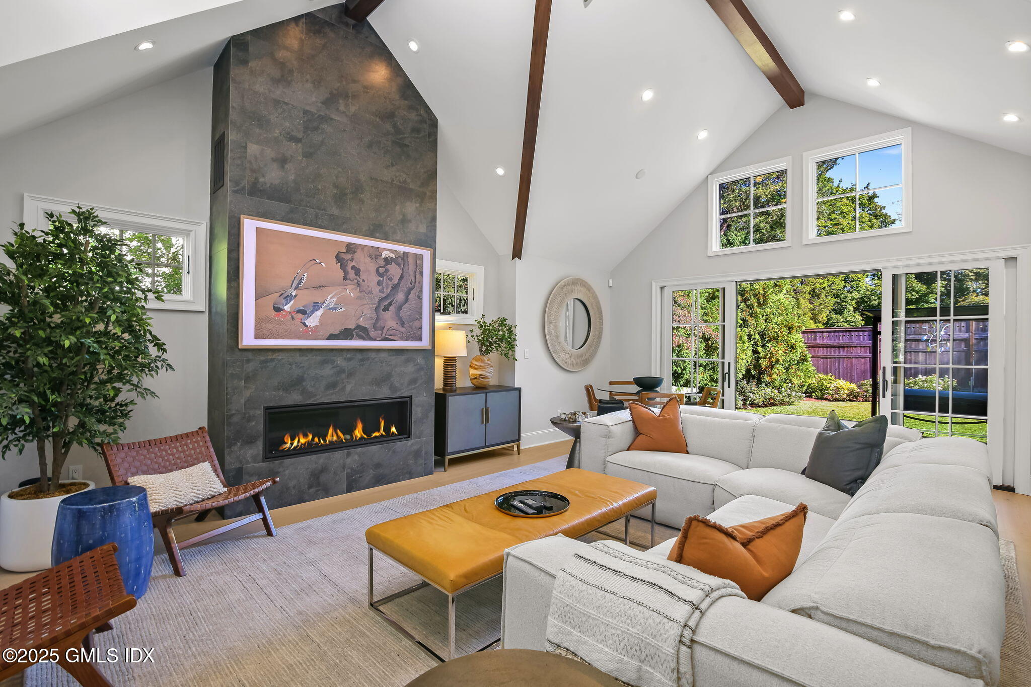 7 Stanwich Road Greenwich, CT 06830 - Photo 21 of 38 a living room with furniture a fireplace and a large window