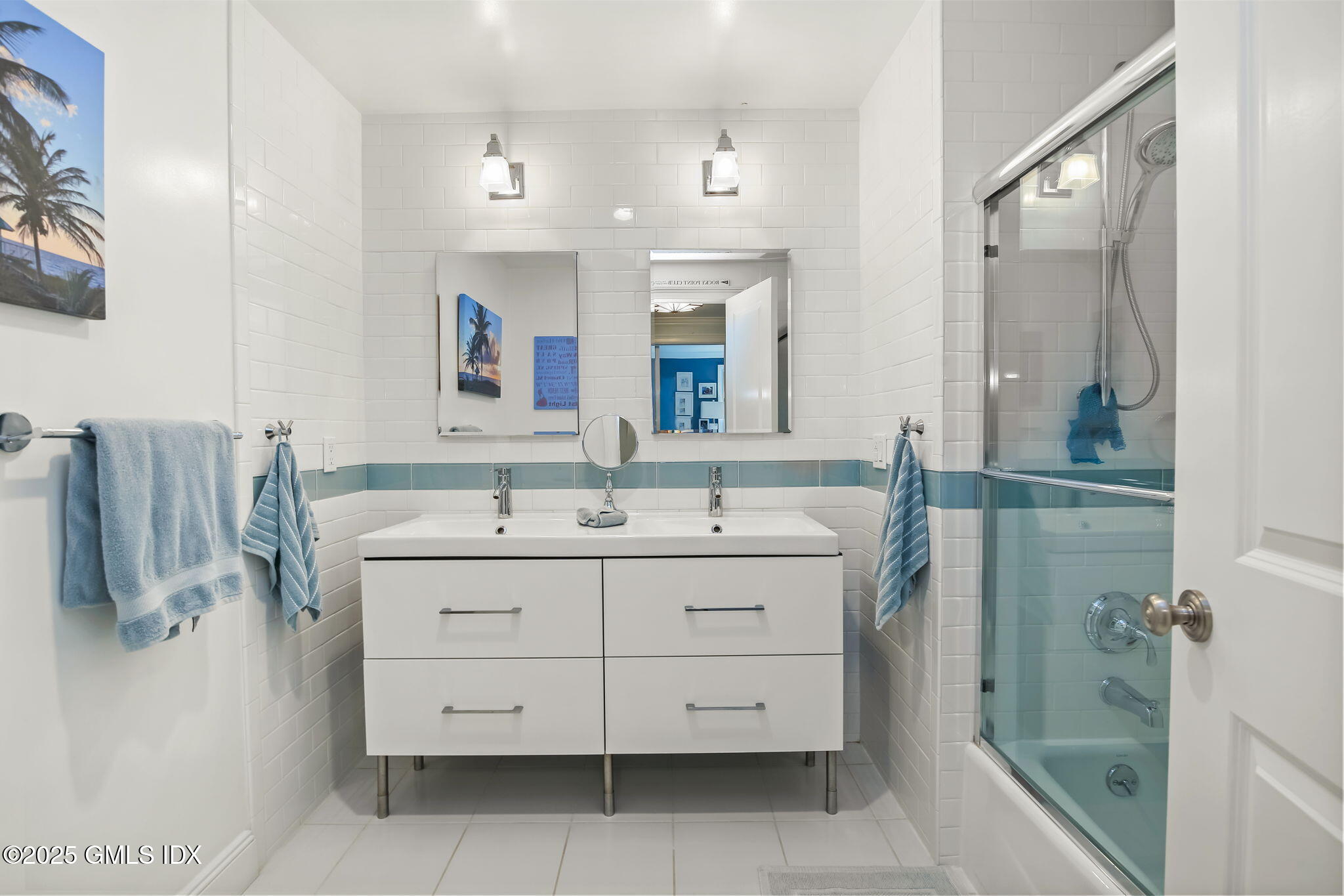 7 Stanwich Road Greenwich, CT 06830 - Photo 29 of 38 a bathroom with a double vanity sink a mirror and shower