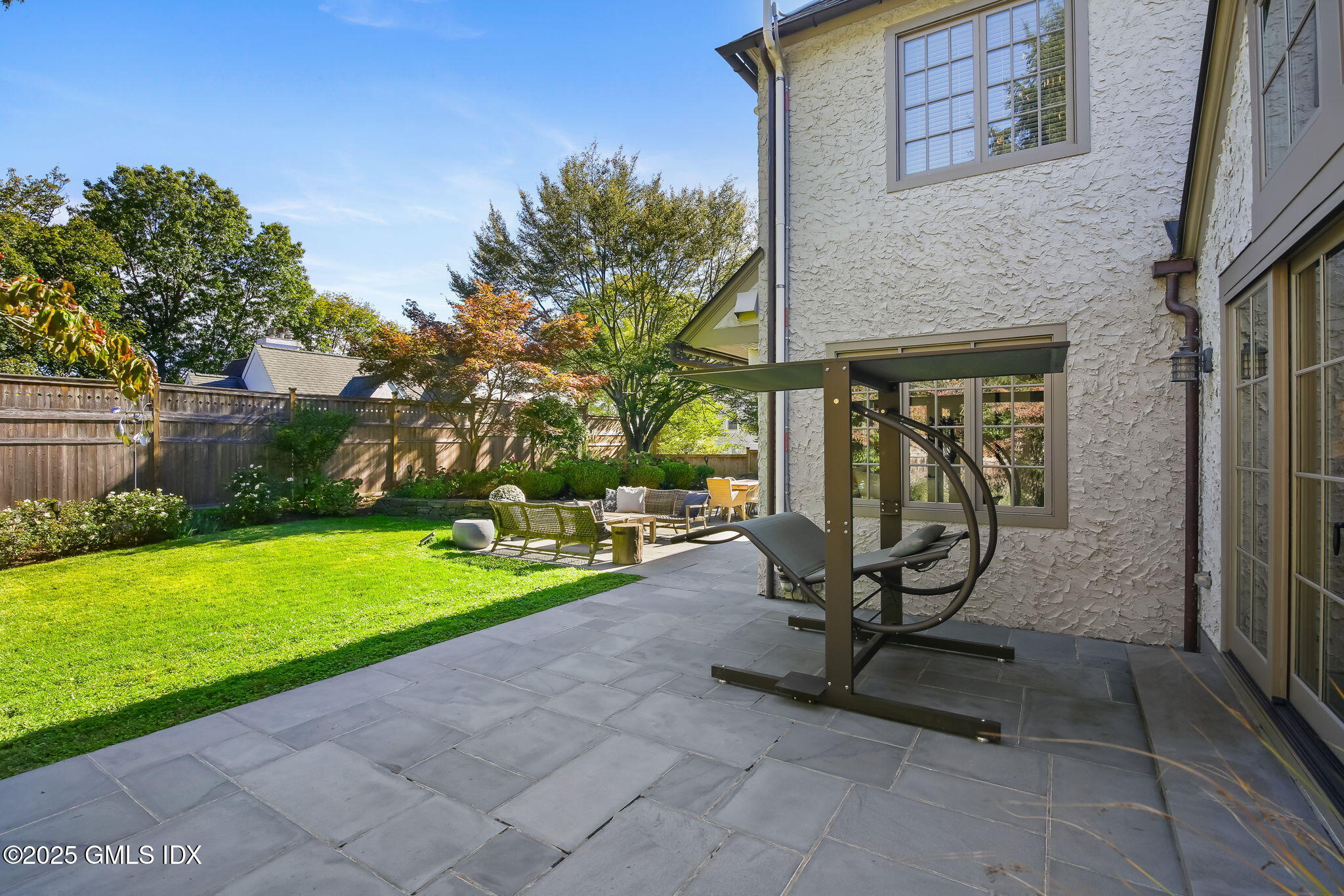 7 Stanwich Road Greenwich, CT 06830 - Photo 33 of 38 a view of a backyard with sitting area and garden
