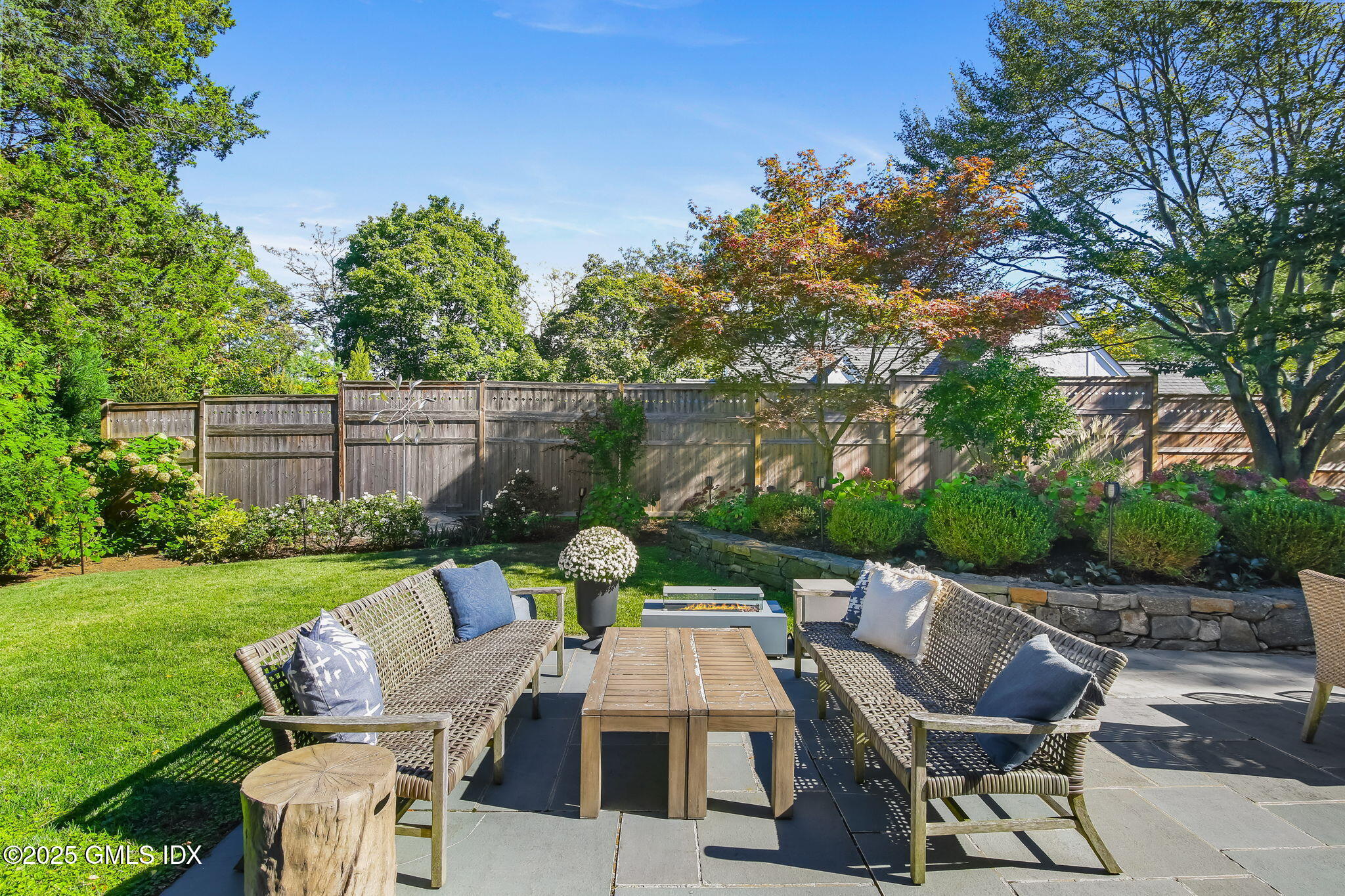 7 Stanwich Road Greenwich, CT 06830 - Photo 34 of 38 a view of a chairs and table in patio next to a yard