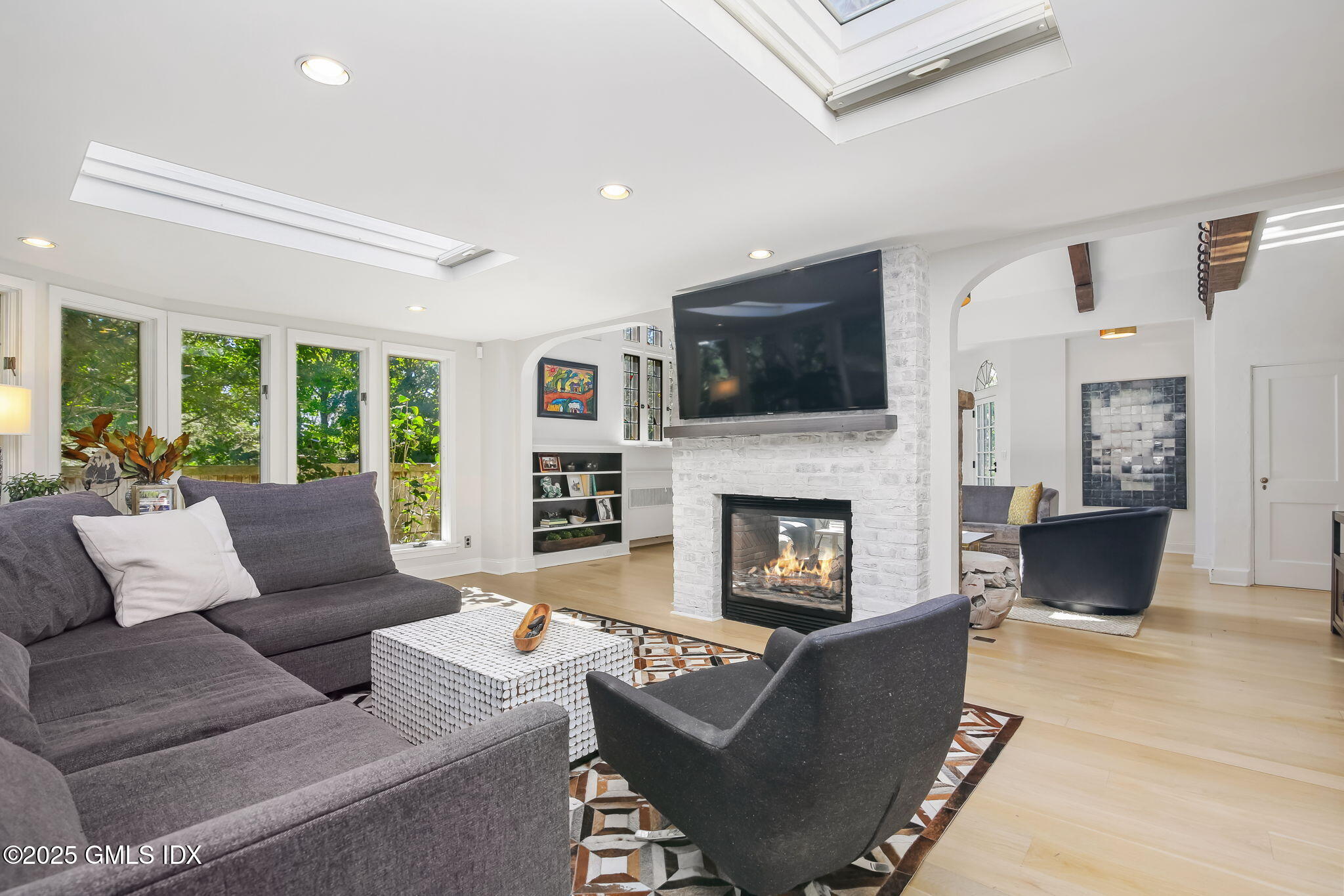 7 Stanwich Road Greenwich, CT 06830 - Photo 9 of 38 a living room with furniture a fireplace and a flat screen tv
