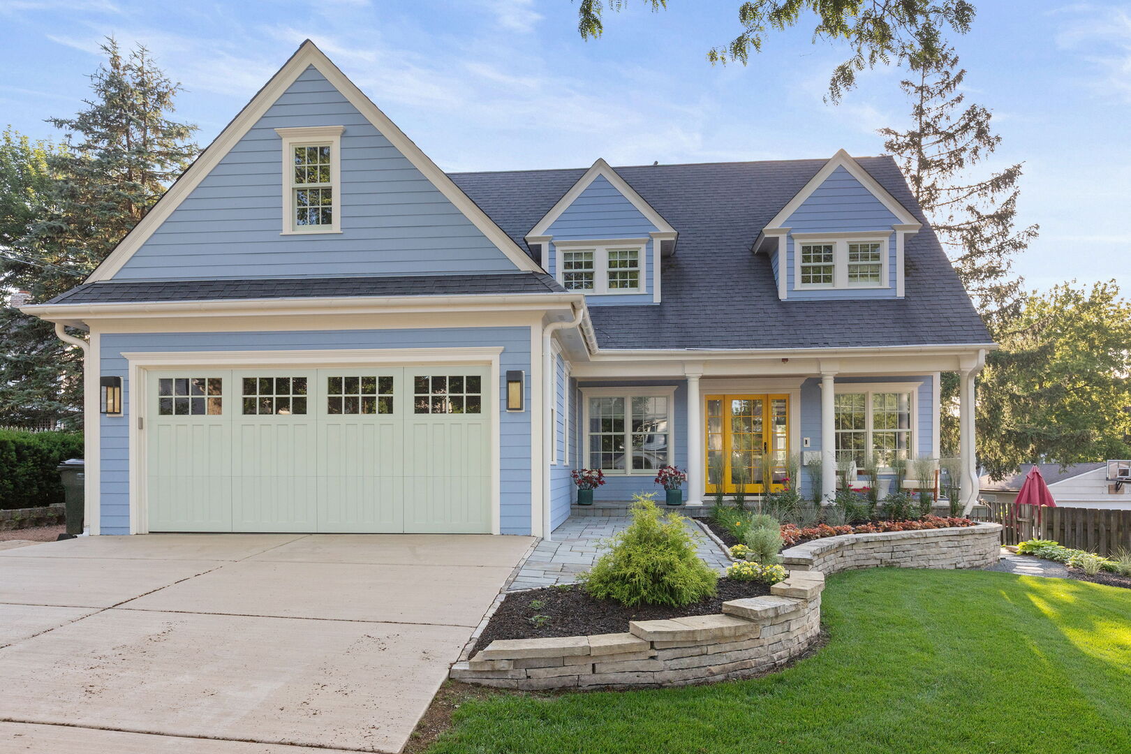 650 South Grove Avenue Barrington, IL 60010 - Photo 2 of 44 a front view of a house with a yard and potted plants