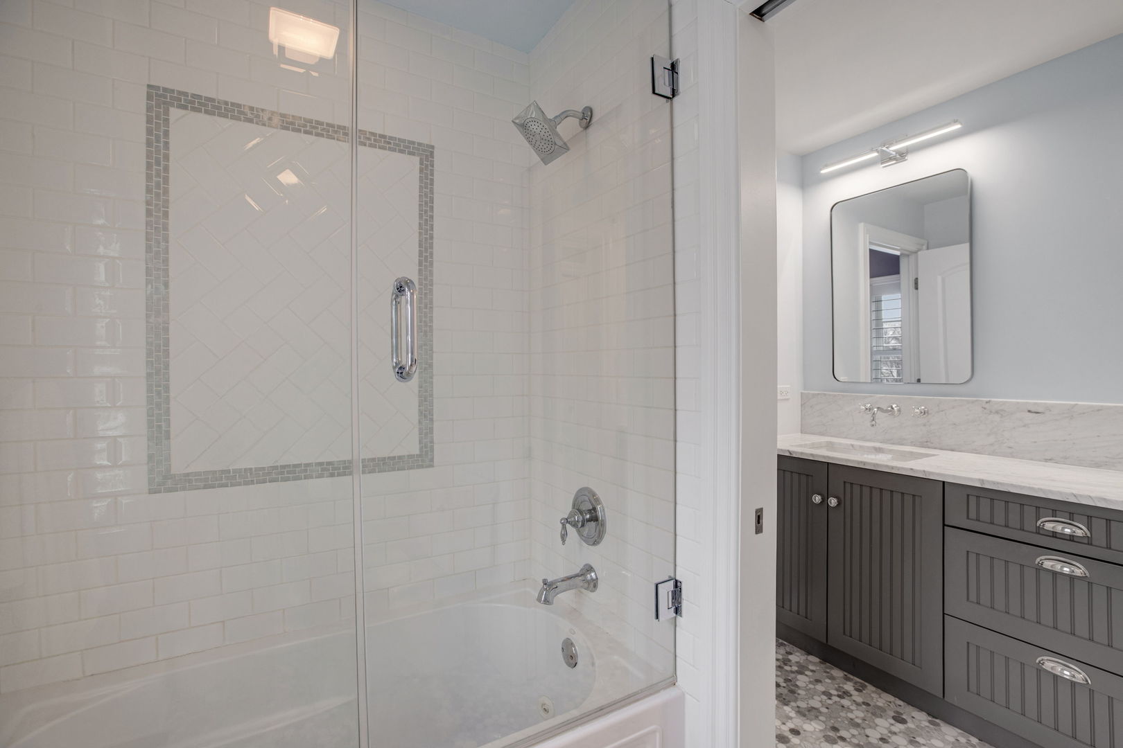 650 South Grove Avenue Barrington, IL 60010 - Photo 27 of 44 a bathroom with a granite countertop sink a mirror and shower