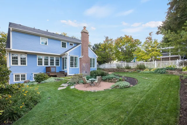 a front view of a house with a yard and potted plants