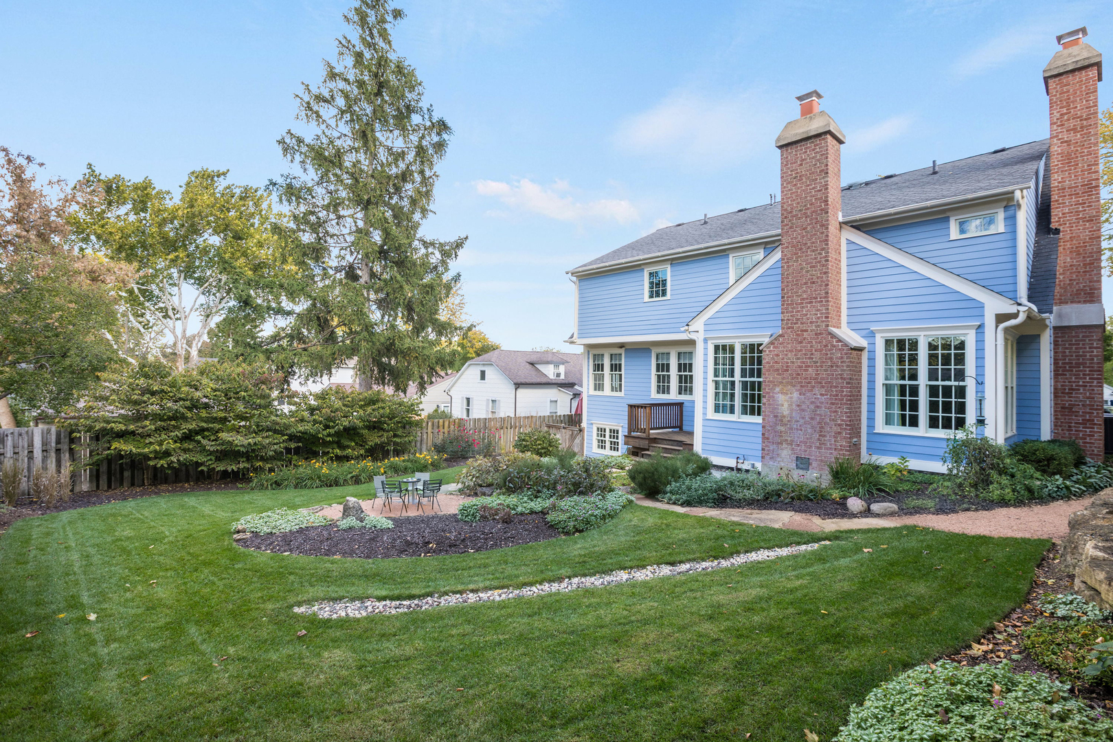 650 South Grove Avenue Barrington, IL 60010 - Photo 40 of 44 a front view of a house with a yard and potted plants
