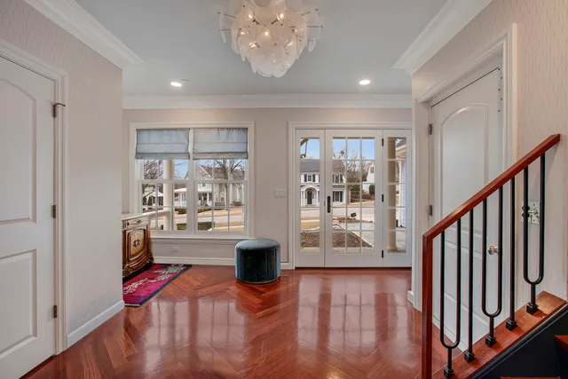 a view of entryway with kitchen and hardwood floor
