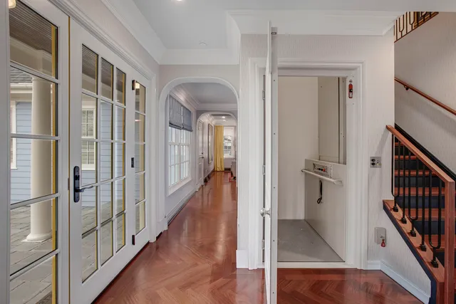 a view of a hallway with wooden floor and staircase