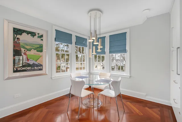a view of a dining room with furniture a chandelier and wooden floor