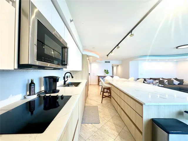 a kitchen with stainless steel appliances a refrigerator sink and cabinets