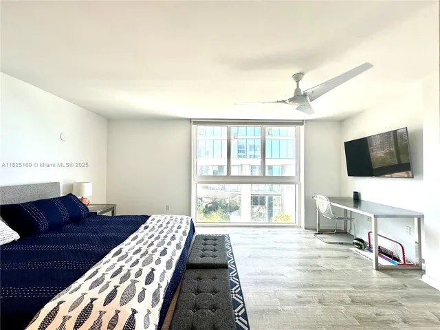 a bathroom with a double vanity sink a mirror and a bathtub