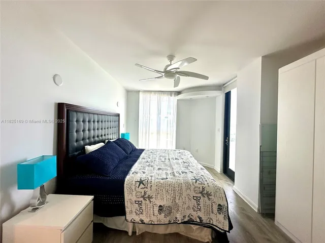 a bedroom with a bed mirror and window