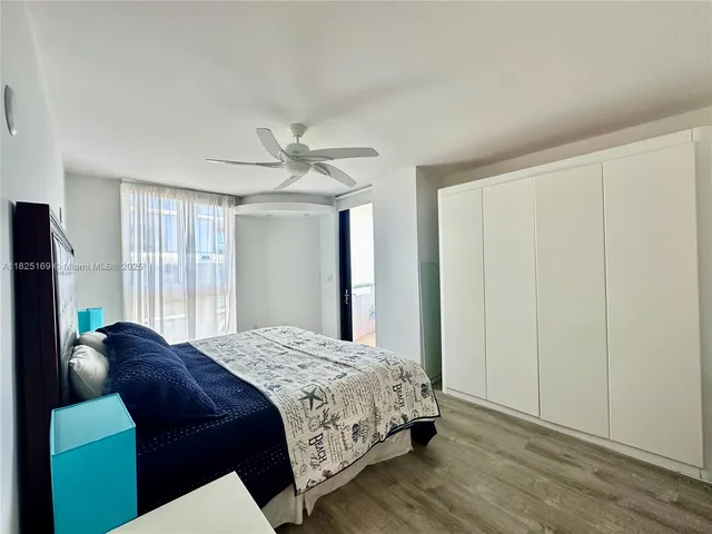 a bedroom with a bed mirror and a window