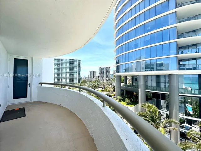a dining room with furniture and a floor to ceiling window