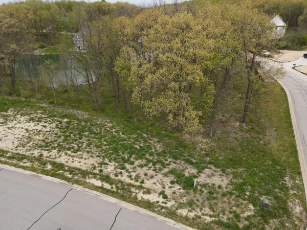 a view of a yard with wooden fence