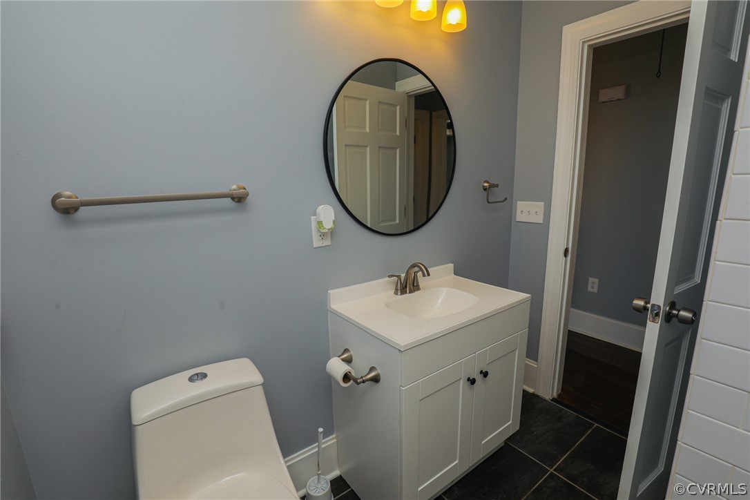 3908 Decatur Street Richmond, VA 23224 - Photo 14 of 23 a bathroom with a sink a toilet and a mirror