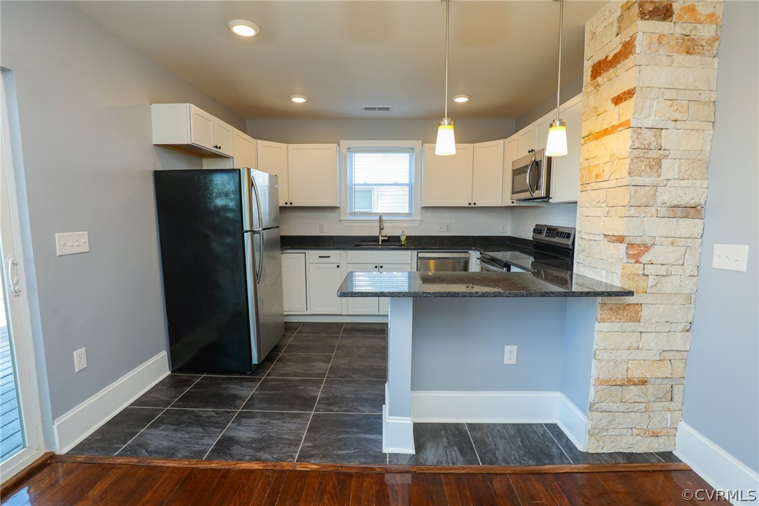 3908 Decatur Street Richmond, VA 23224 - Photo 8 of 23 a kitchen with kitchen island granite countertop a refrigerator and a stove