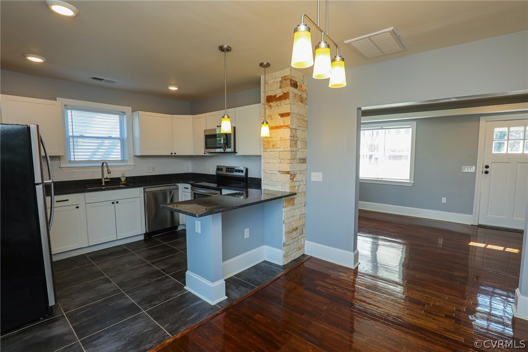 3908 Decatur Street Richmond, VA 23224 - Photo 9 of 23 a kitchen with granite countertop a sink cabinets and stainless steel appliances