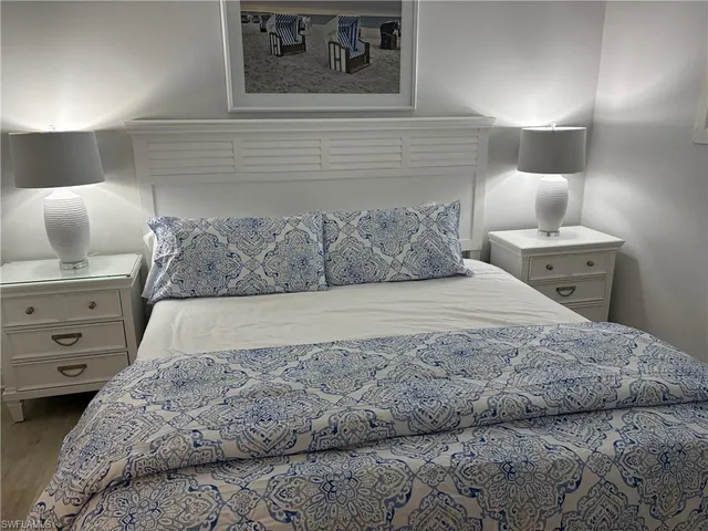 a large bed sitting in a bedroom and dresser