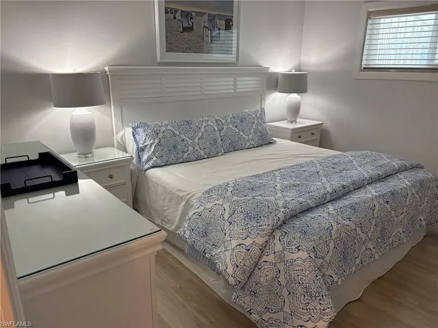 a bedroom with a bed and a lamp