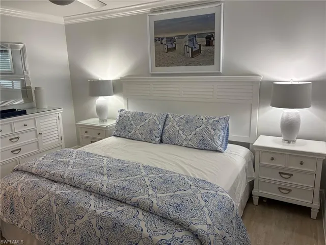 a bedroom with a bed and a night stand