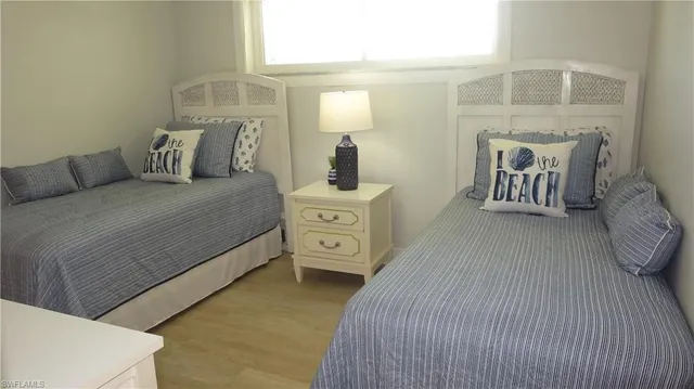 a bedroom with a bed and a night stand