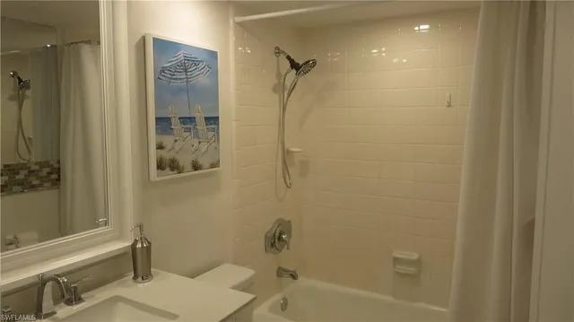 a bathroom with a shower and a sink