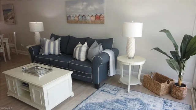 a living room with furniture a table and a potted plant