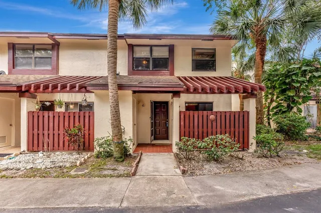 a view of a house with a backyard