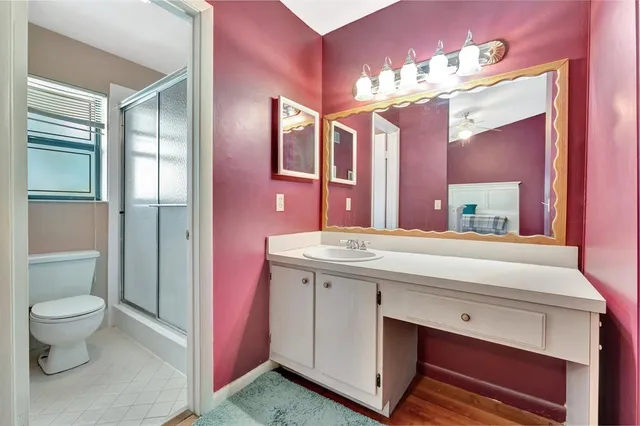 a bedroom with a bed dresser and a window