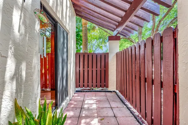 a view of a house with a backyard and a potted plants