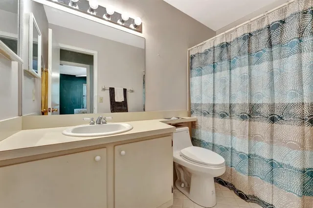 an aerial view of a house with a yard and lake view