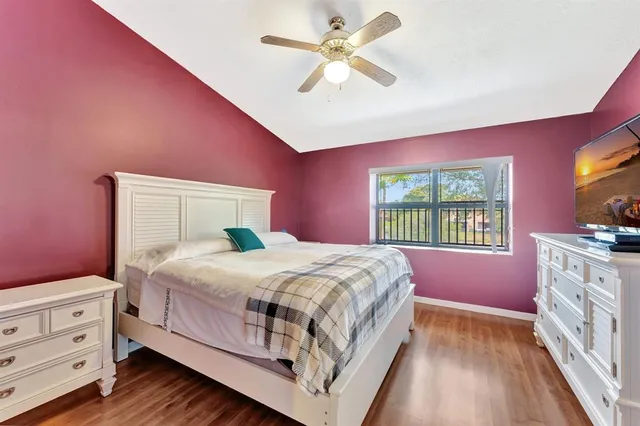 an aerial view of a residential houses with outdoor space and trees all around