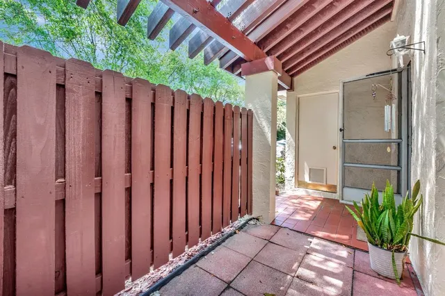 a kitchen with stainless steel appliances granite countertop a stove top oven a sink dishwasher and a refrigerator with wooden cabinets