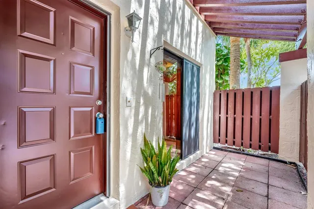 a kitchen that has a lot of cabinets in it and stainless steel appliances