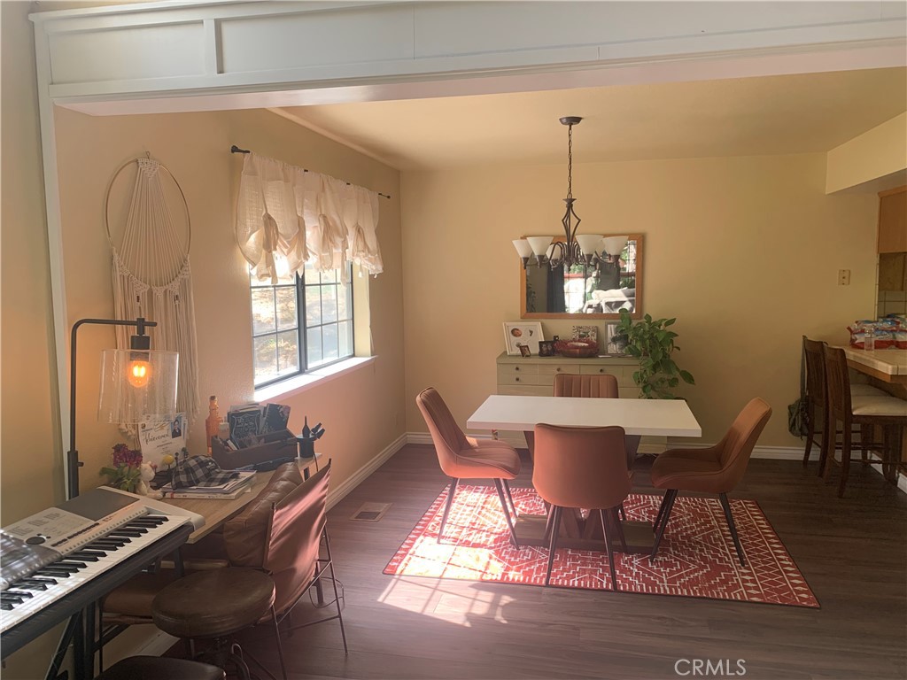 40513 Saddleback Road Bass Lake, CA 93604 - Photo 8 of 11 a dining room with furniture a chandelier and wooden floor