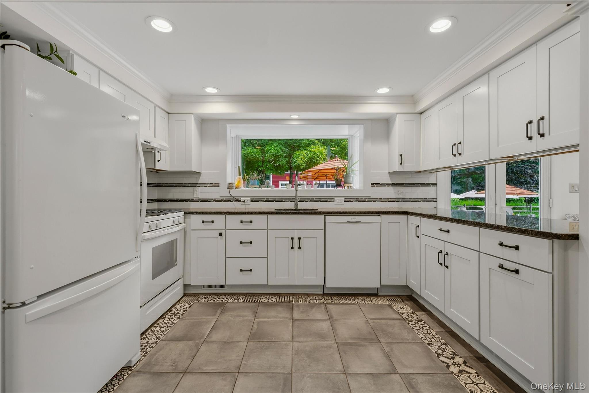 324 Haverstraw Road Suffern, NY 10901 - Photo 13 of 50 a kitchen with white cabinets stainless steel appliances and a window
