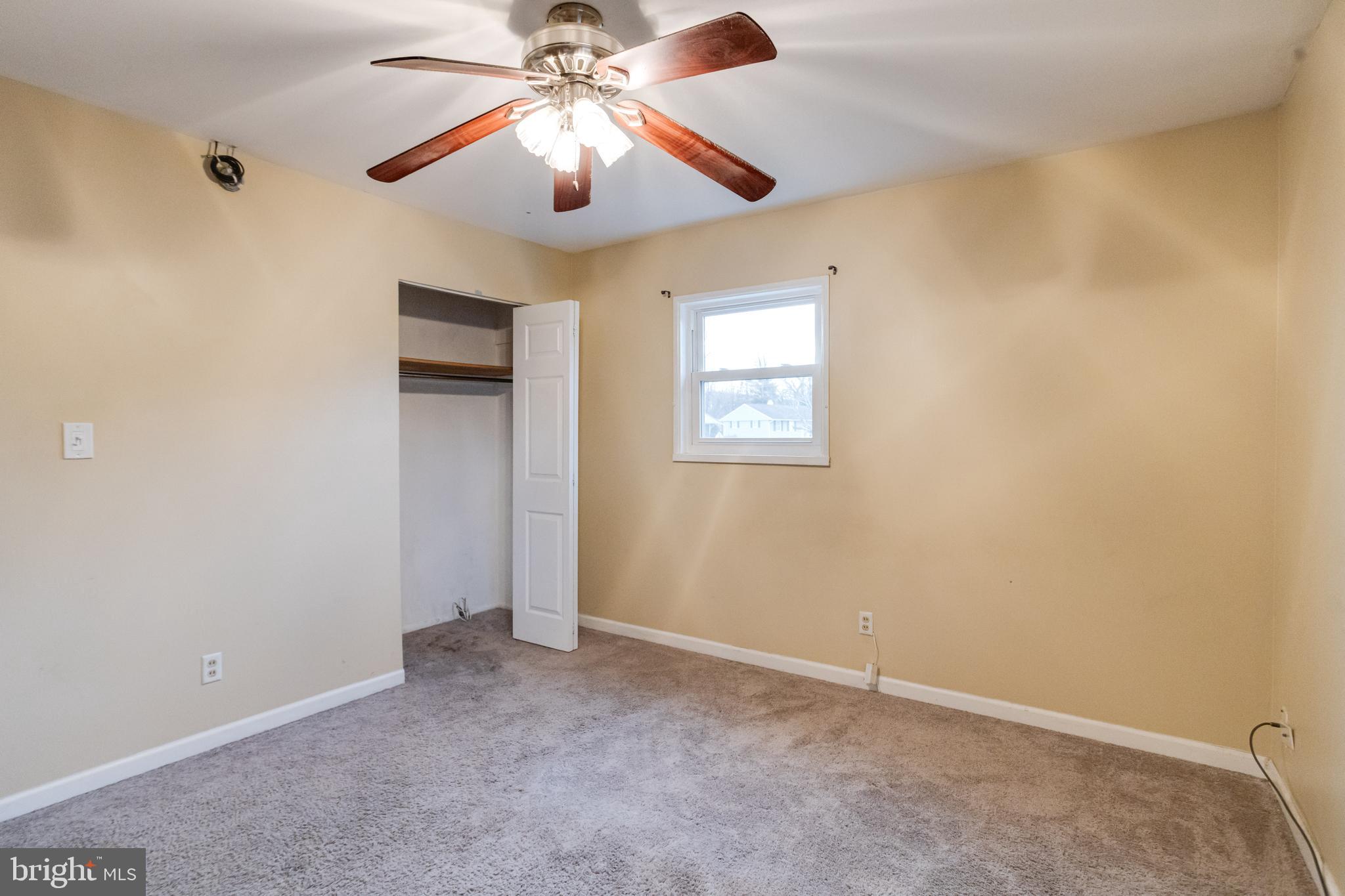 2020 Hanson Road Edgewood, MD 21040 - Photo 19 of 34 an empty room with a chandelier fan and windows