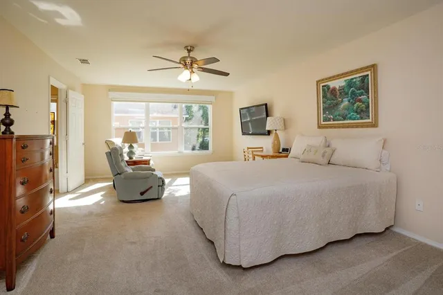 a bedroom with a bed couch and a window