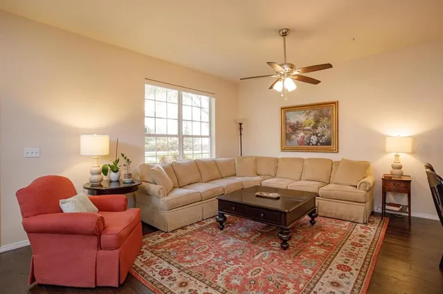 a living room with furniture a chandelier and a window