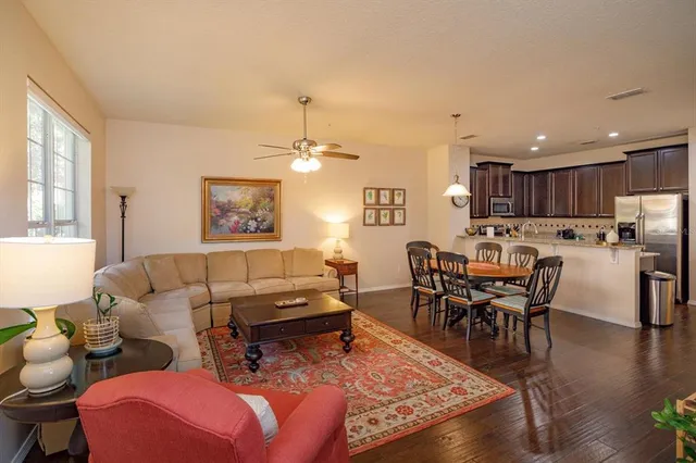 a living room with furniture and kitchen view