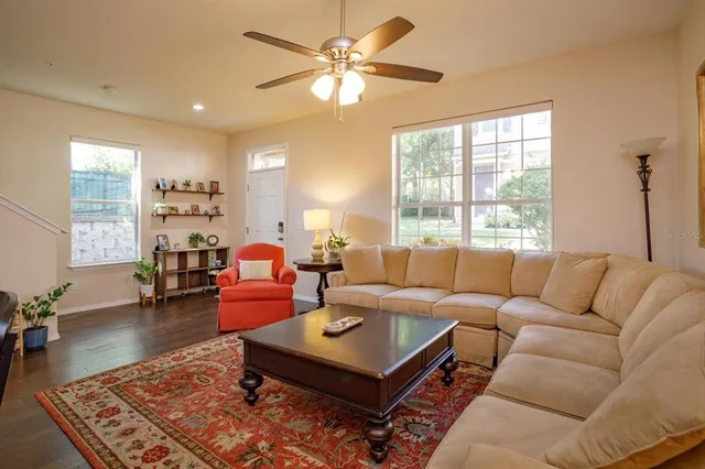 a living room with furniture a table and a large window