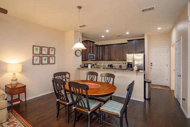 a view of a dining room with furniture and wooden floor