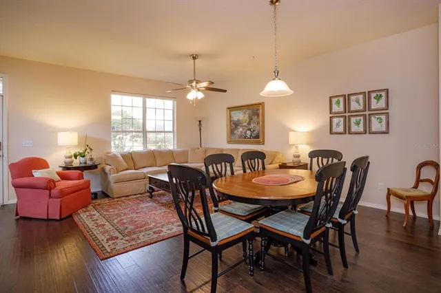 a view of a a dining room with furniture window and wooden floor