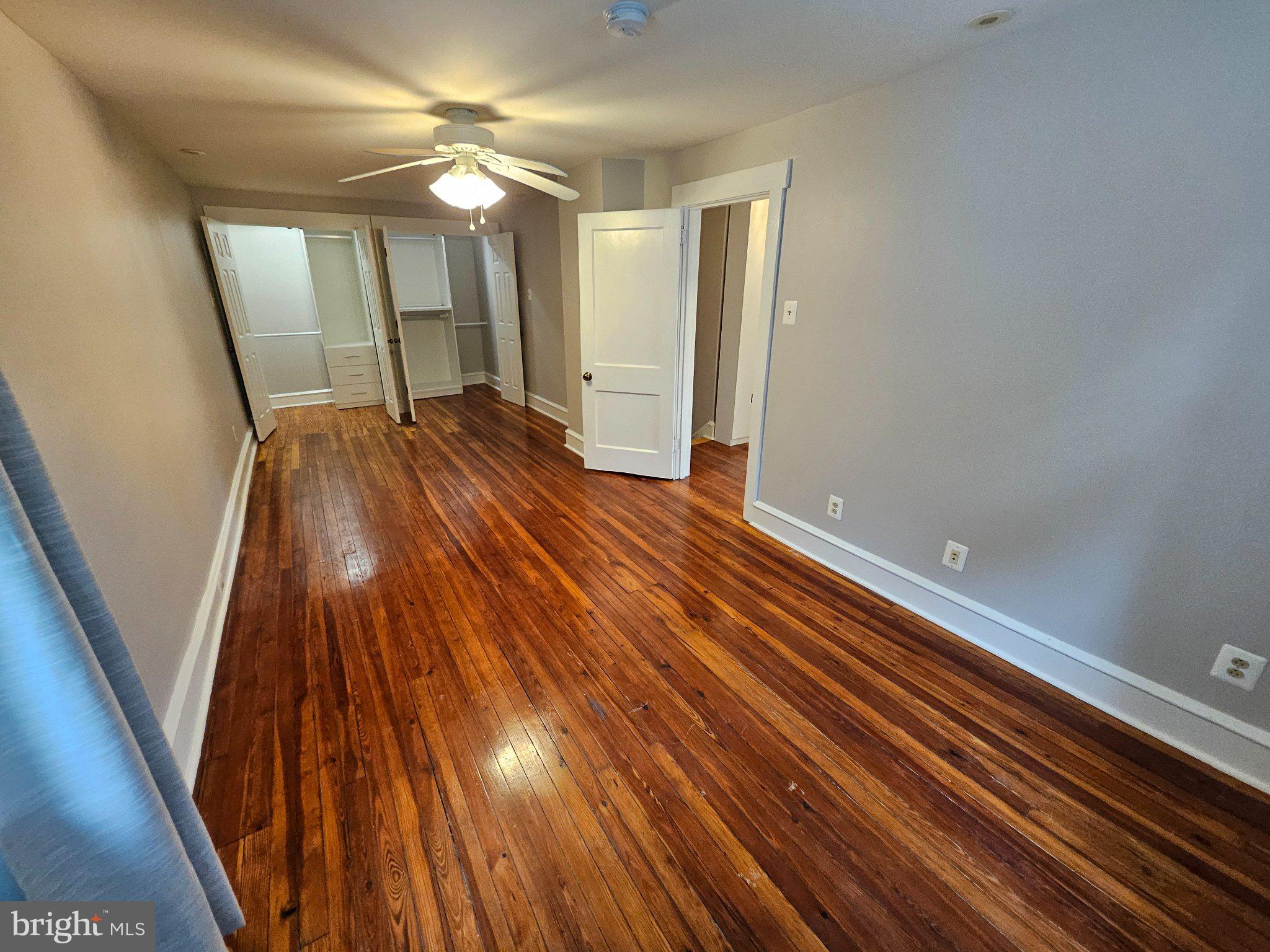 6 Arthur Road, Unit FRONT Rosemont, PA 19010 - Photo 14 of 24 Spacious room with gleaming hardwood floors.