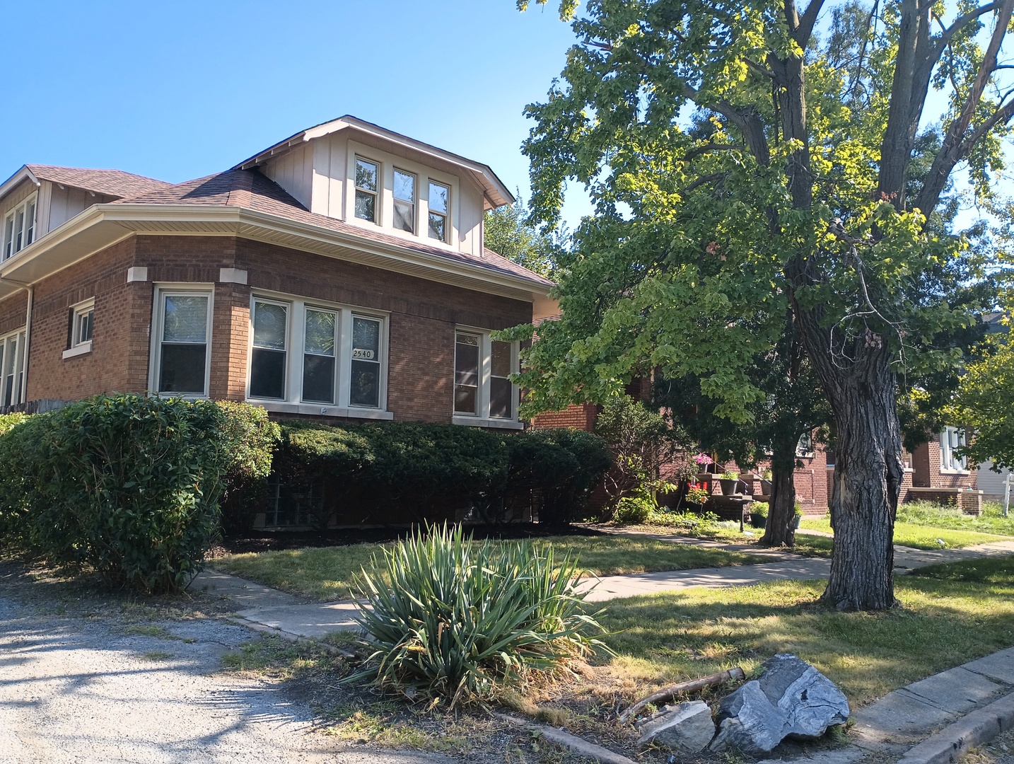 2540 Lewis Street Blue Island, IL 60406 - Photo 1 of 27 a front view of a house with a garden