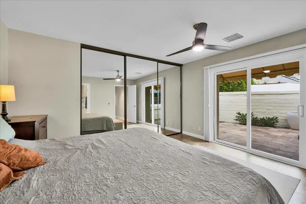 a bedroom with a large bed and a chandelier