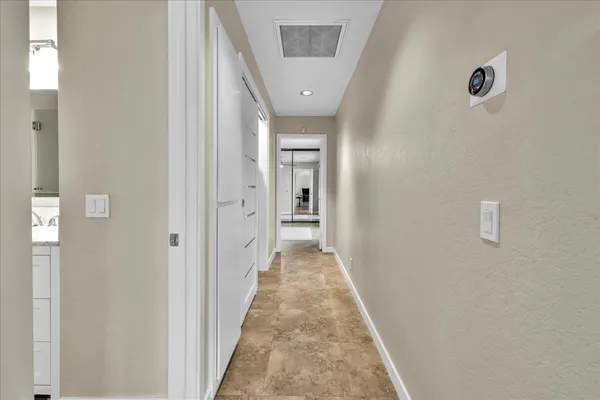 a view of a hallway with wooden floor