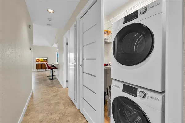 a view of a hallway with washer and dryer